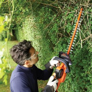 Black and DECKER 36 V Cordless Hedge Trimmer cutting hedges